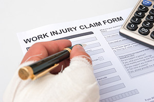 injured worker filling out work injury claim form